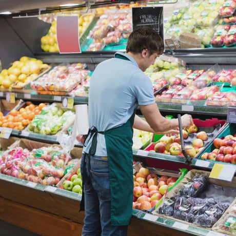 Store worker stocking fruit