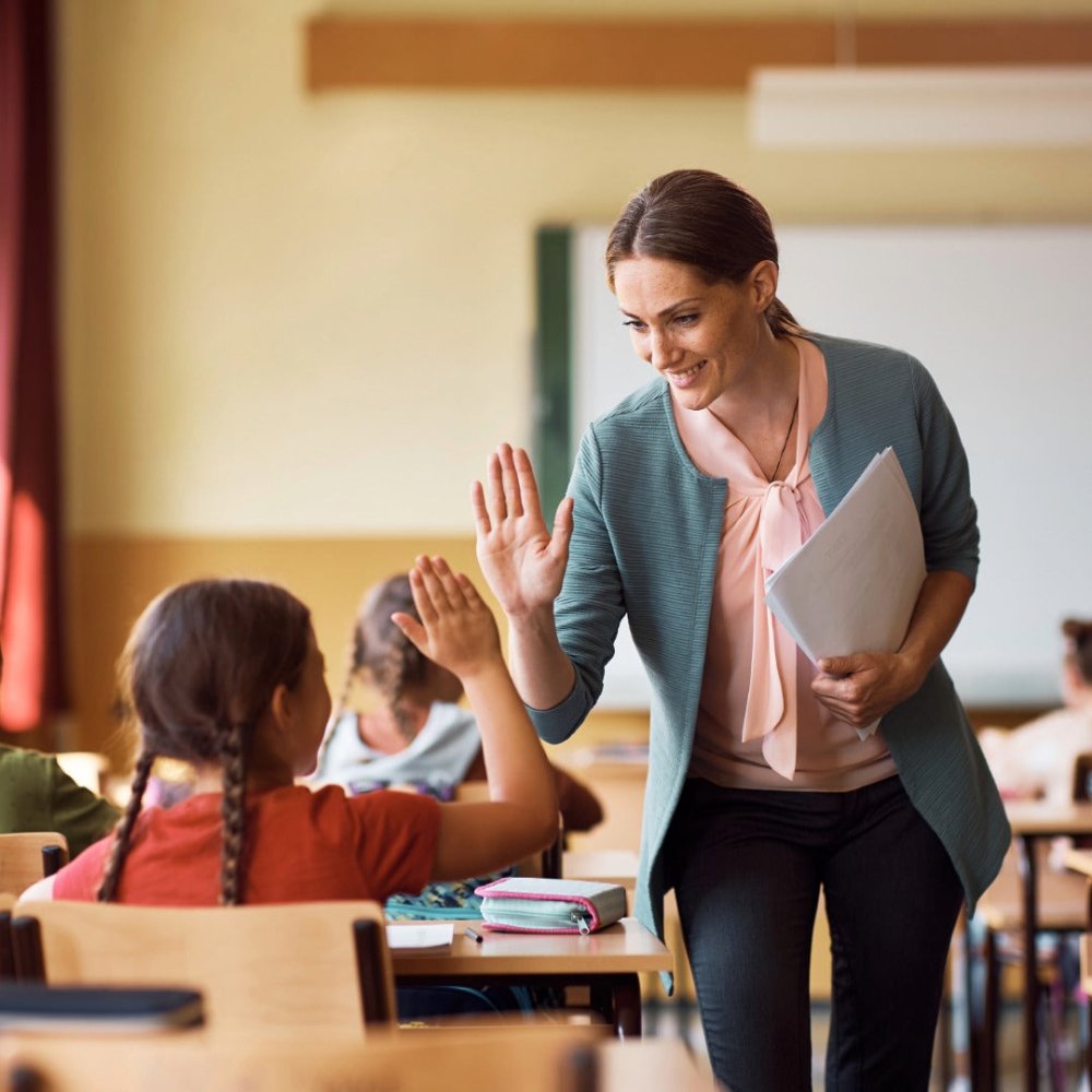 Teacher congratulating student
