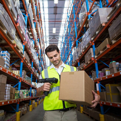 Warehouse worker scanning a box label