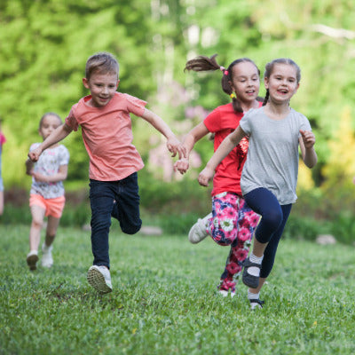 Image showing several children running across a lawn