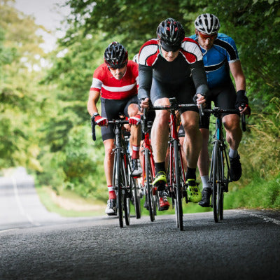 Image showing four men cycling along a road