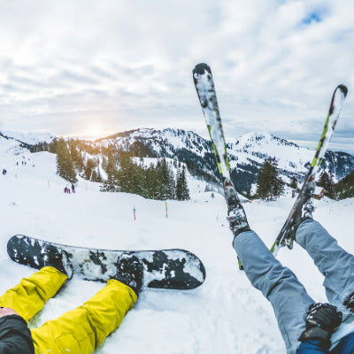 Image showing a skier and snowboarder sitting on a snowy slope