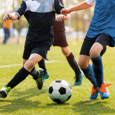 Image showing three soccer players around a soccer ball