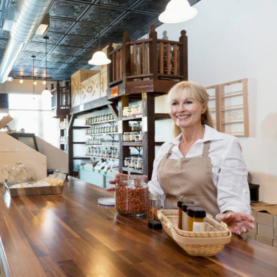 Image of a woman standing behind a counter at a shop