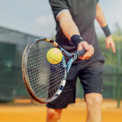 Image showing a man hitting a tennis ball with a racket